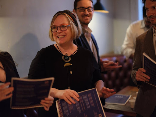 Rabbi Katja Vehlow holding a flyer