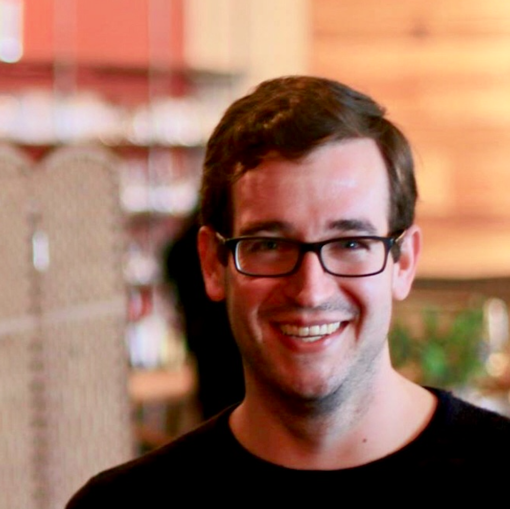 man smiling with glasses on