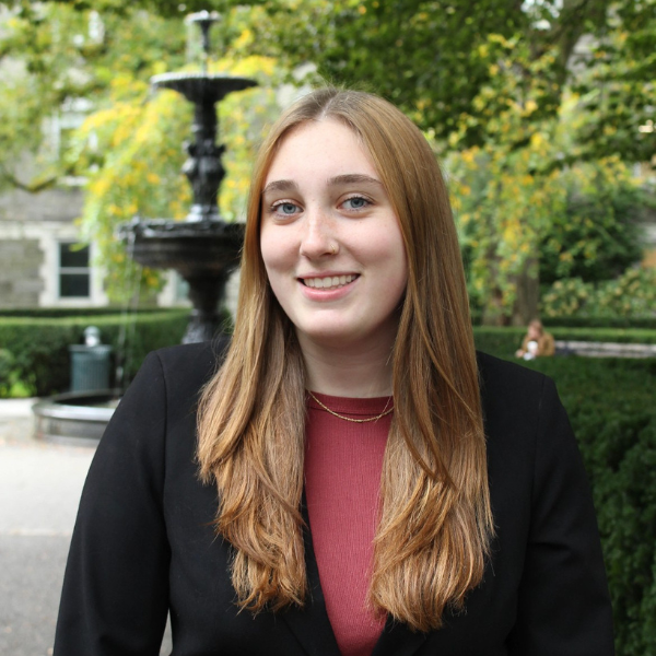 student standing in front of fountain