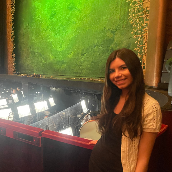 student in front of stage