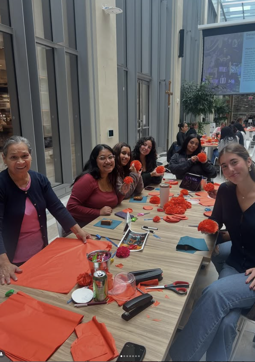 Fordham students and community members at event making flowers