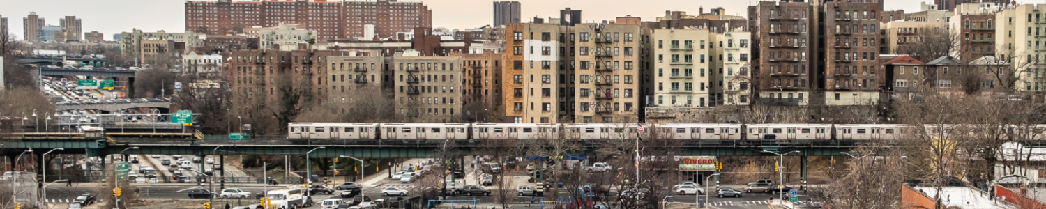 Image of 4 elevated train in West Bronx over the Cross Bronx Expressway big apartment buildings in background