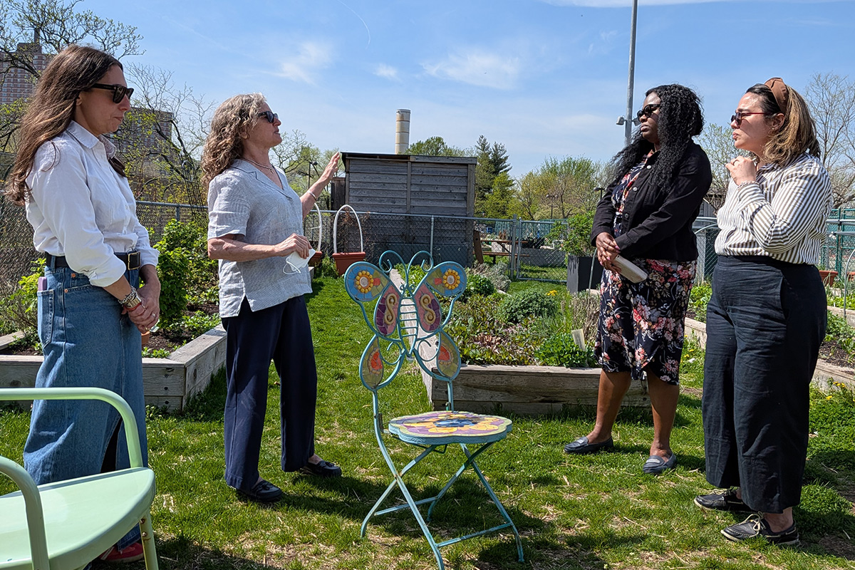 Partners in conversation near some urban gardens as part of the HORT visit