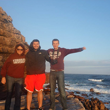 Fordham students standing along a seaside cliff