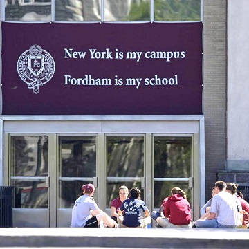 Students sitting outside career services building on campus