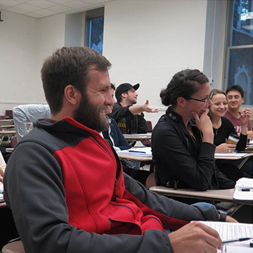 IPED students smiling in a classroom