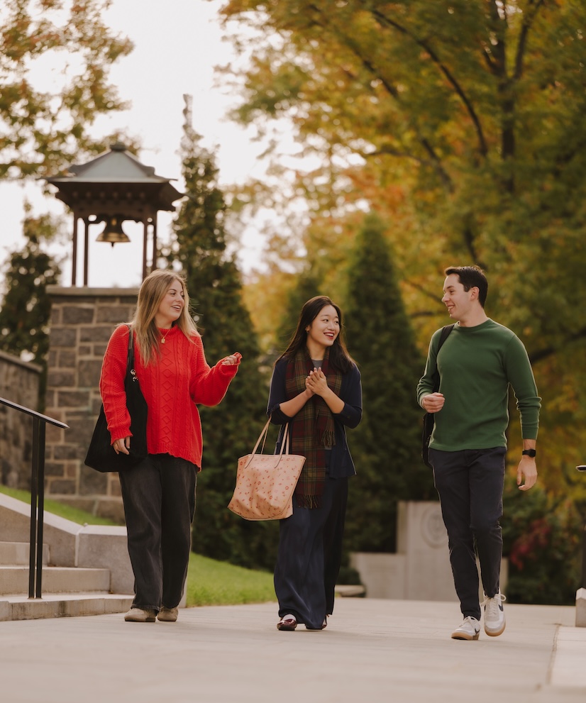 Fordham University students walking at the Rose Hill campus