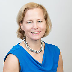 Annette McLaughlin posing in front of a white wall