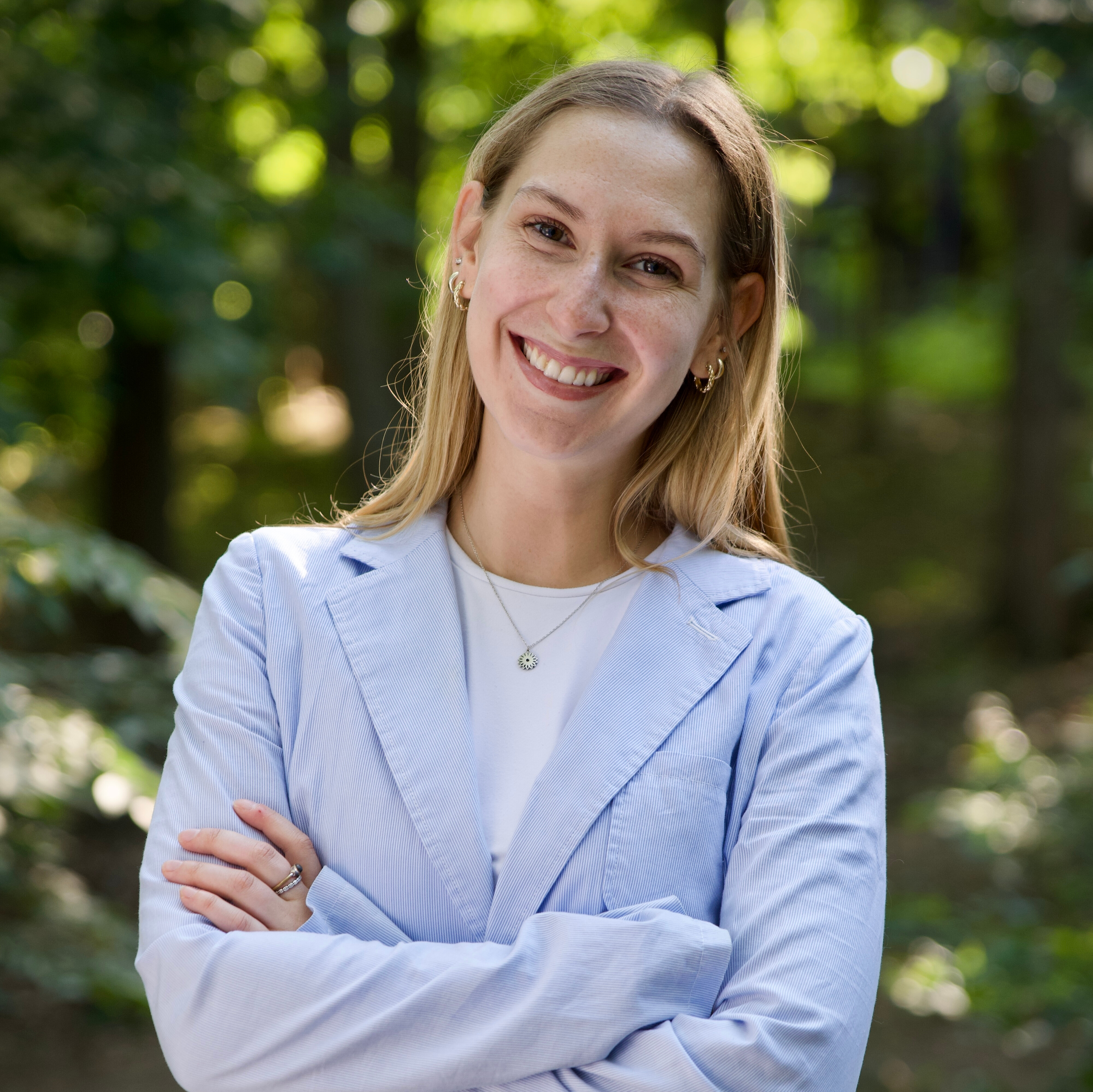 Cate Eggers smiling in front of trees outside