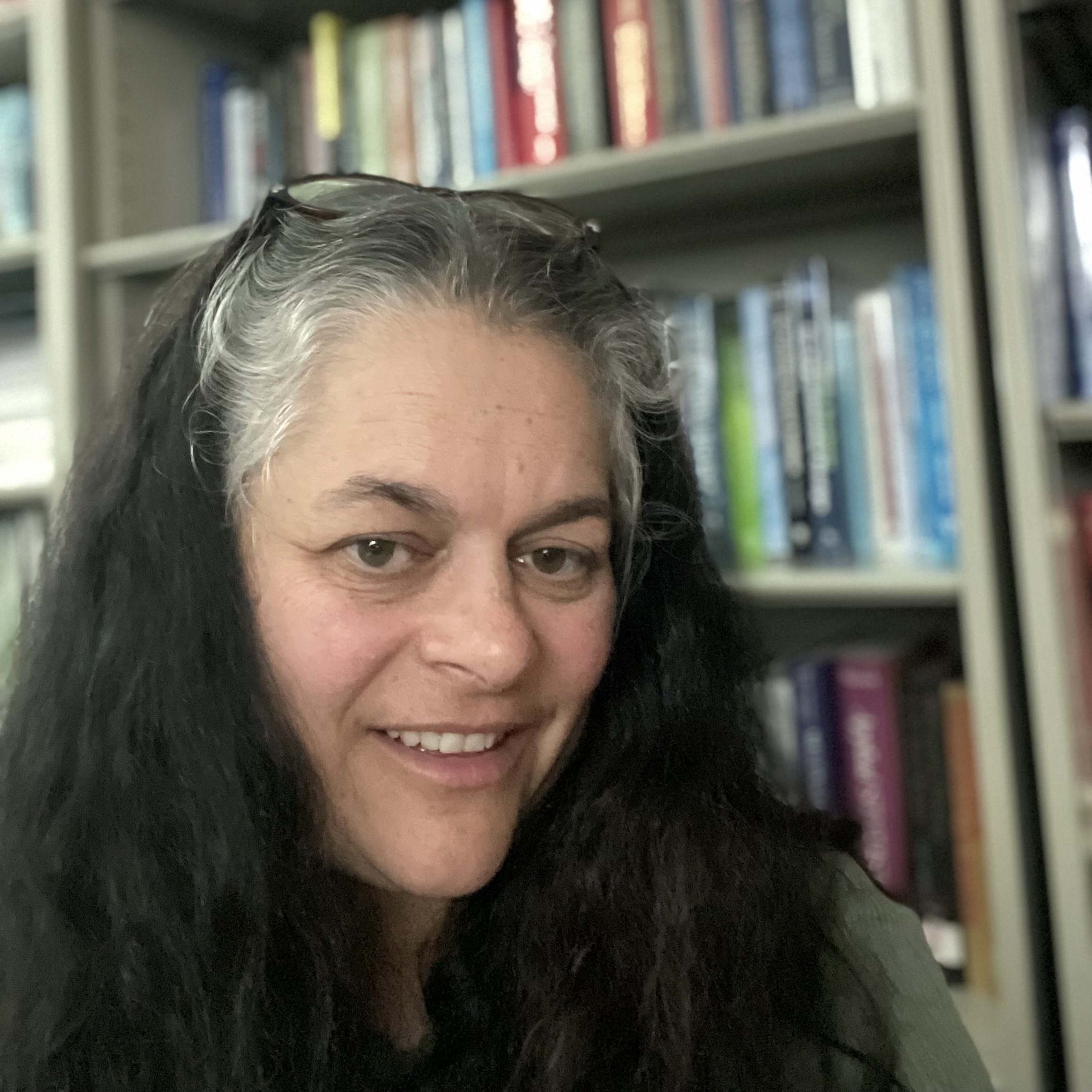 Profile picture of Dr. Betsy McCoach in front of a bookcase
