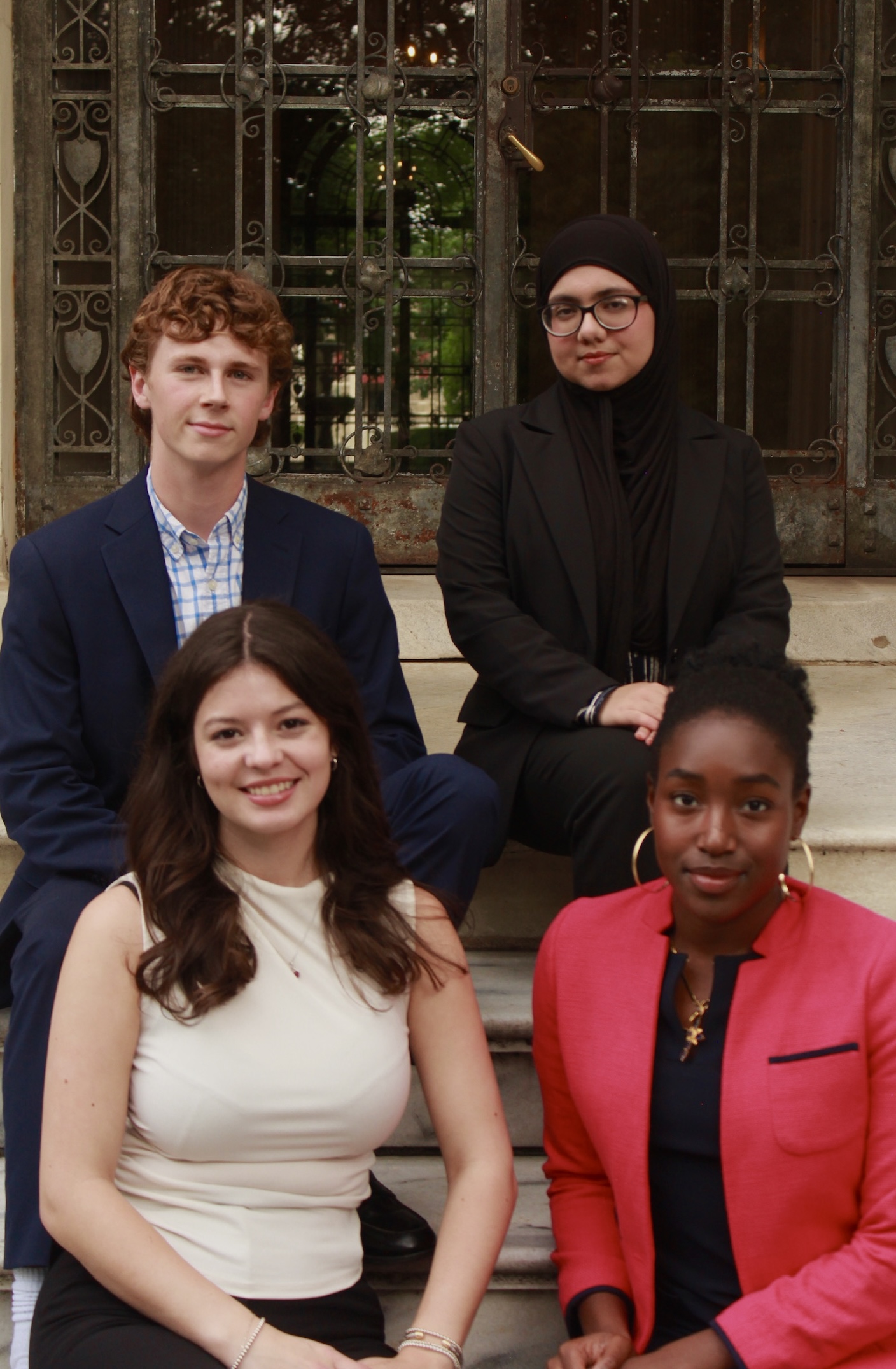 Four orientation coordinators seated; Connor Olson top left, Haniyyah Usmani top right, Kat Taylor bottom left, Whitney Egbe bottom right
