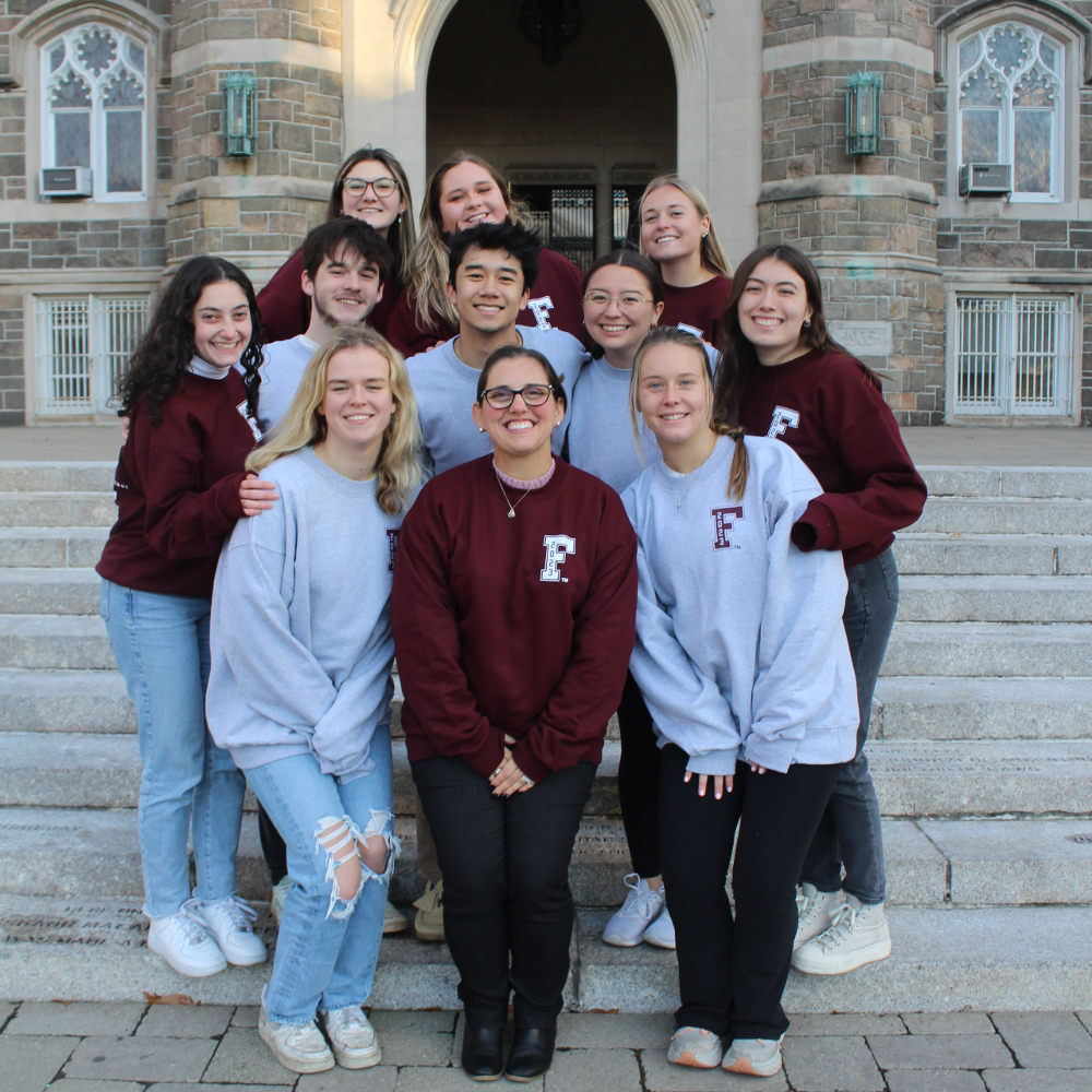 Senior Week 2023 Committee standing in front of building at Fordham Rose Hill.