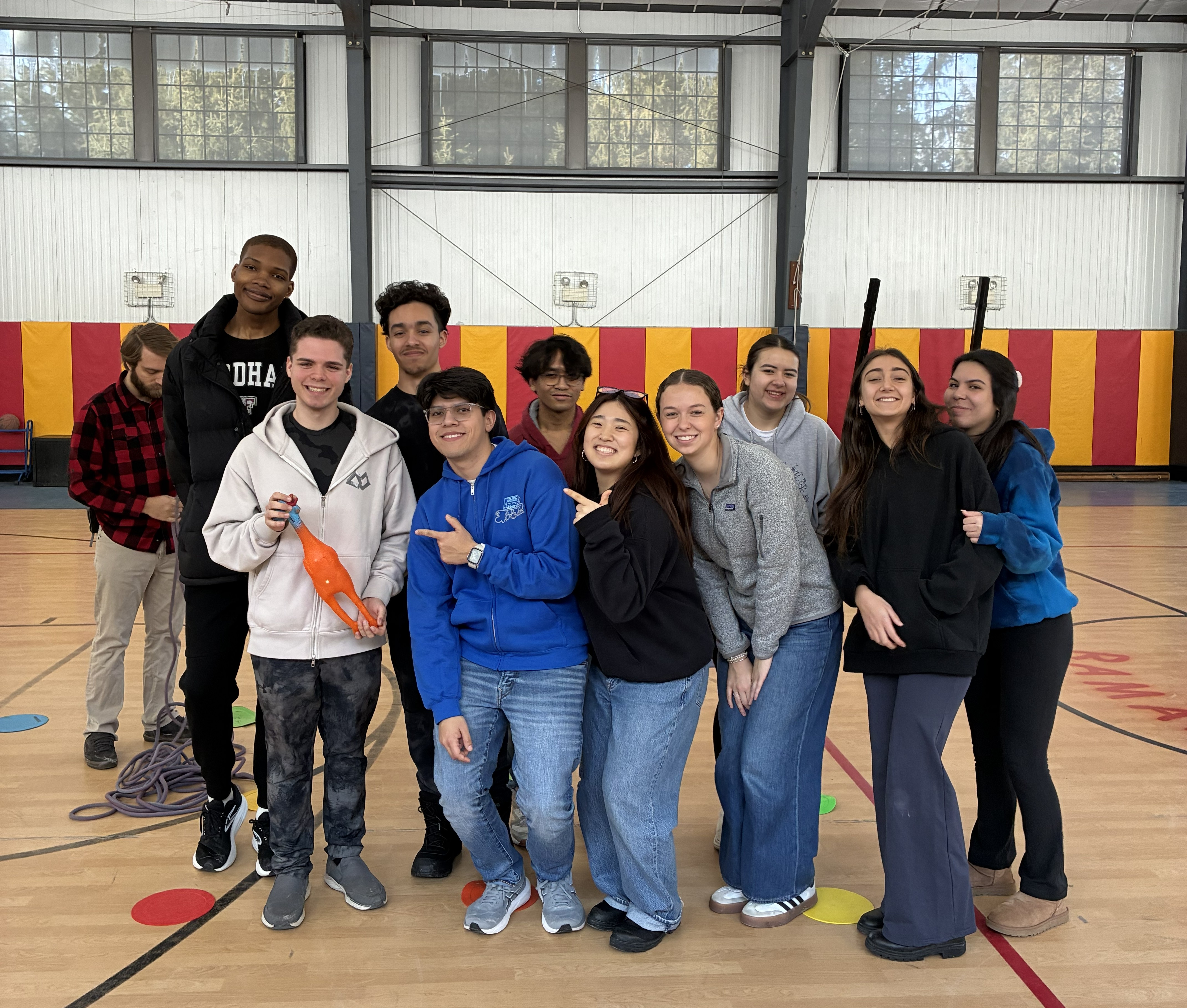 Students standing and posing in a gym
