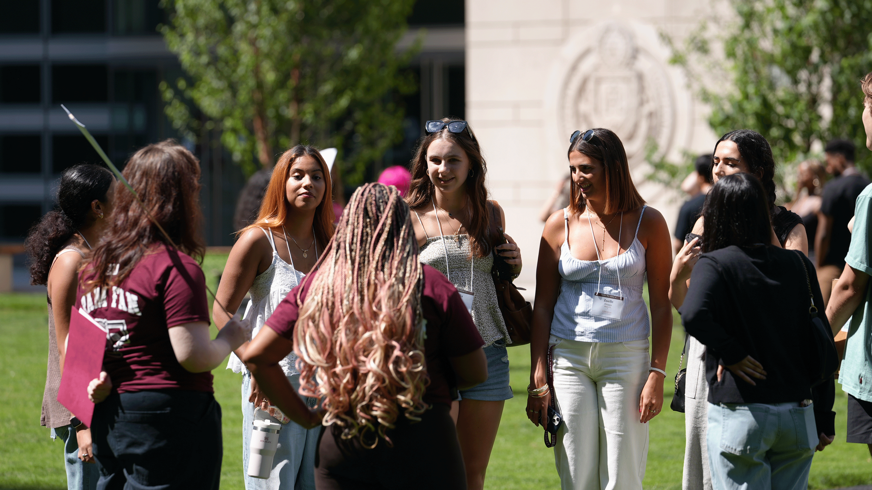 A group of female students ask questions of orientation leaders at summer orientation on the Lincoln Center campus