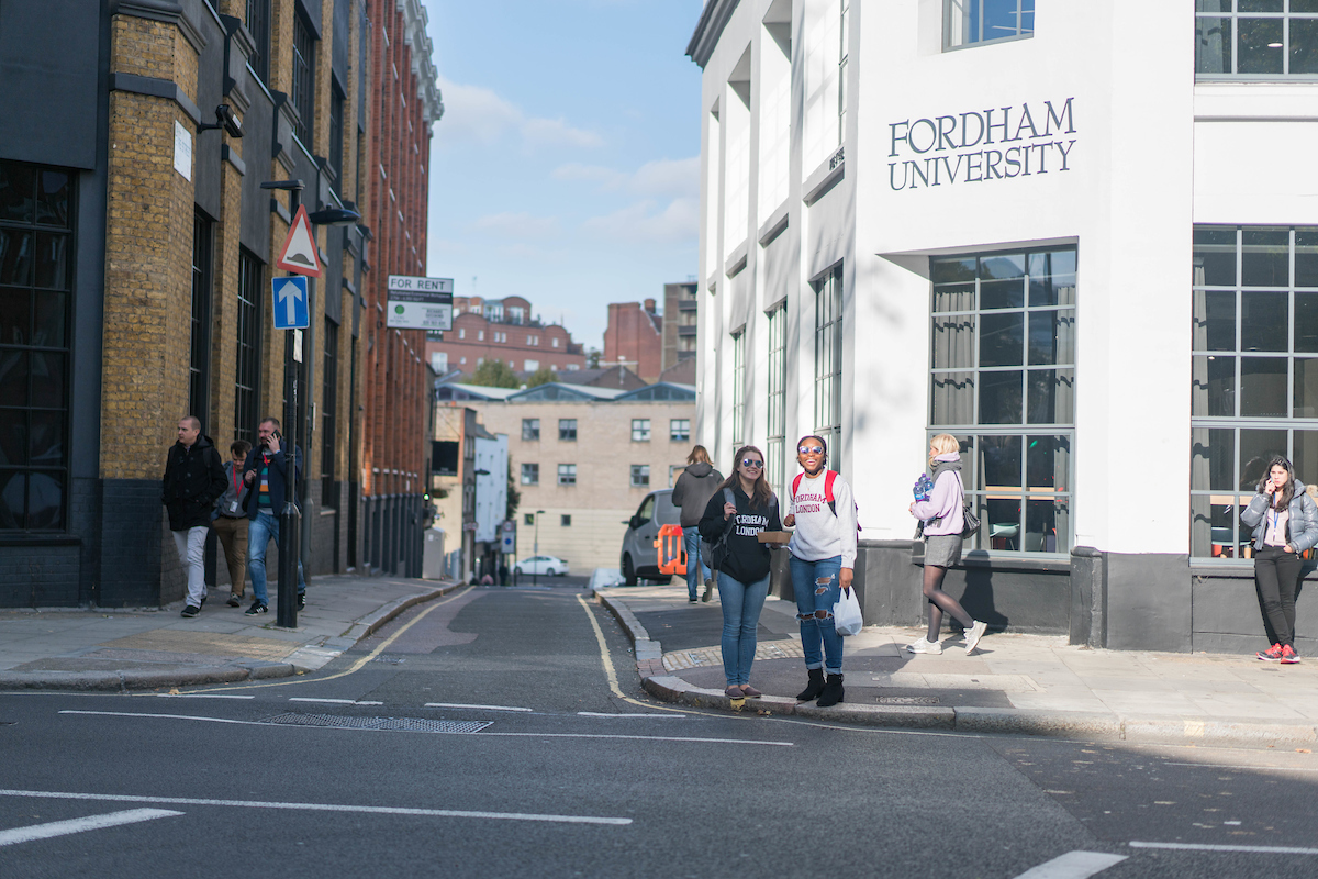 Two students stand outside Fordham London building