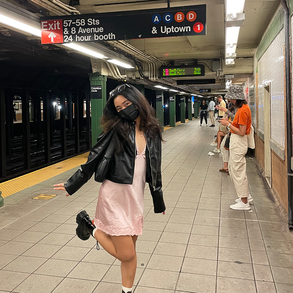 Student stands on subway platform