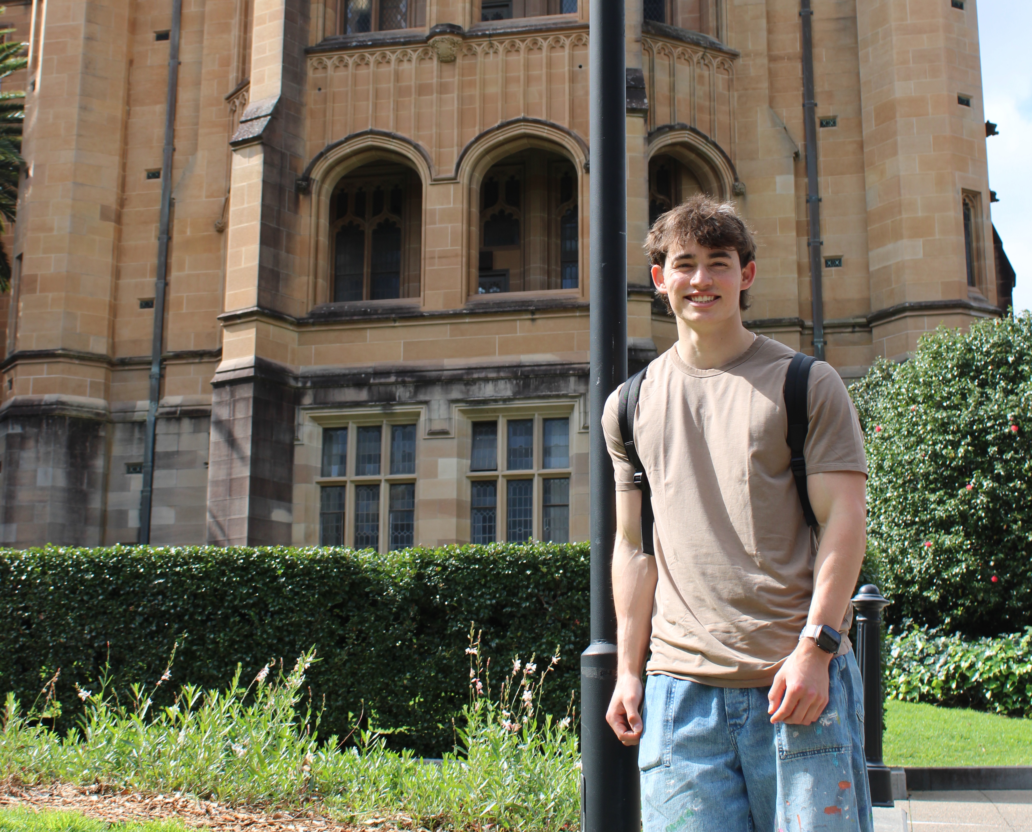 Student standing in front of a building