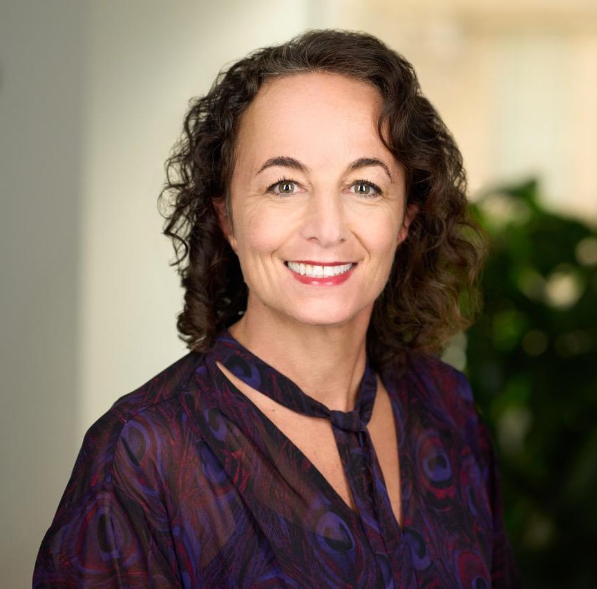 Liz Kanter with plant in the background