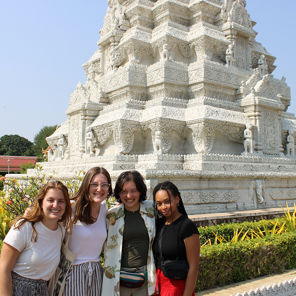 Students stand in front of temple