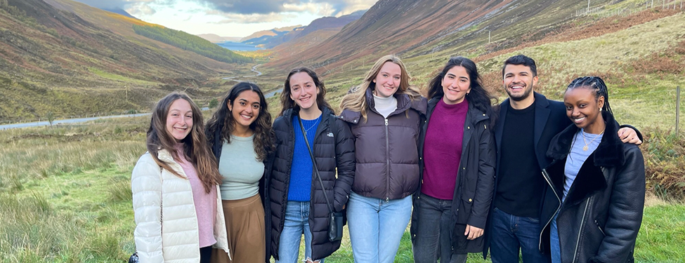 Students stand in front of landscape