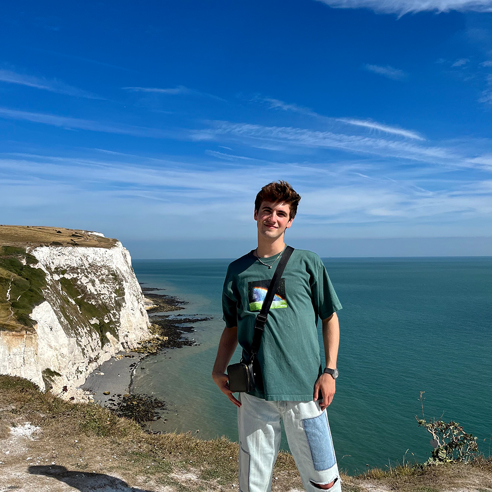 student standing by cliffs