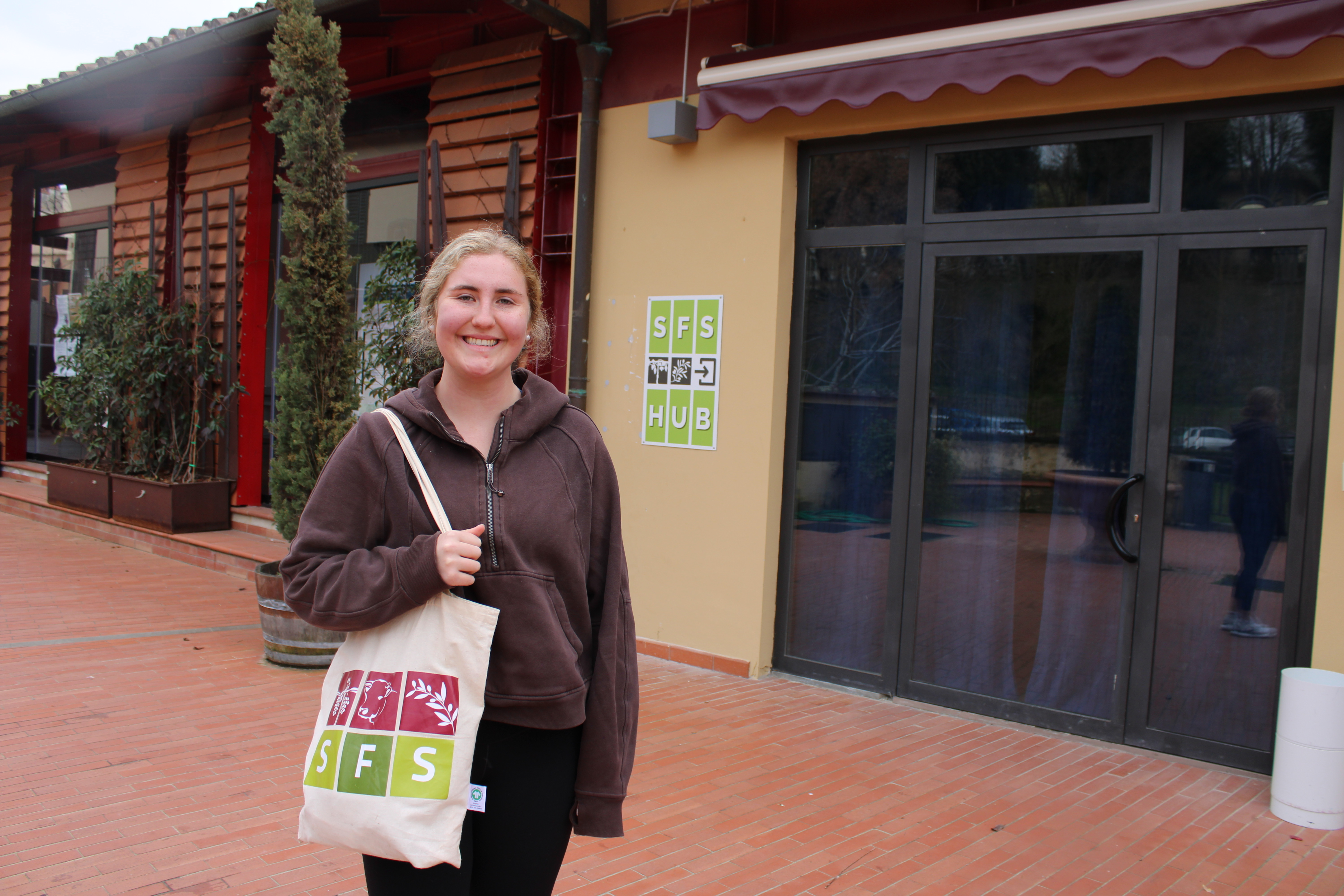 Student standing in front of a building