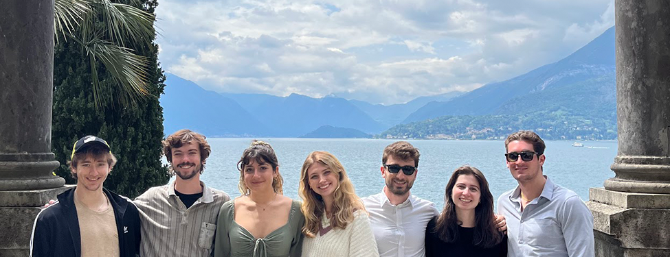 Students standing together in front of water