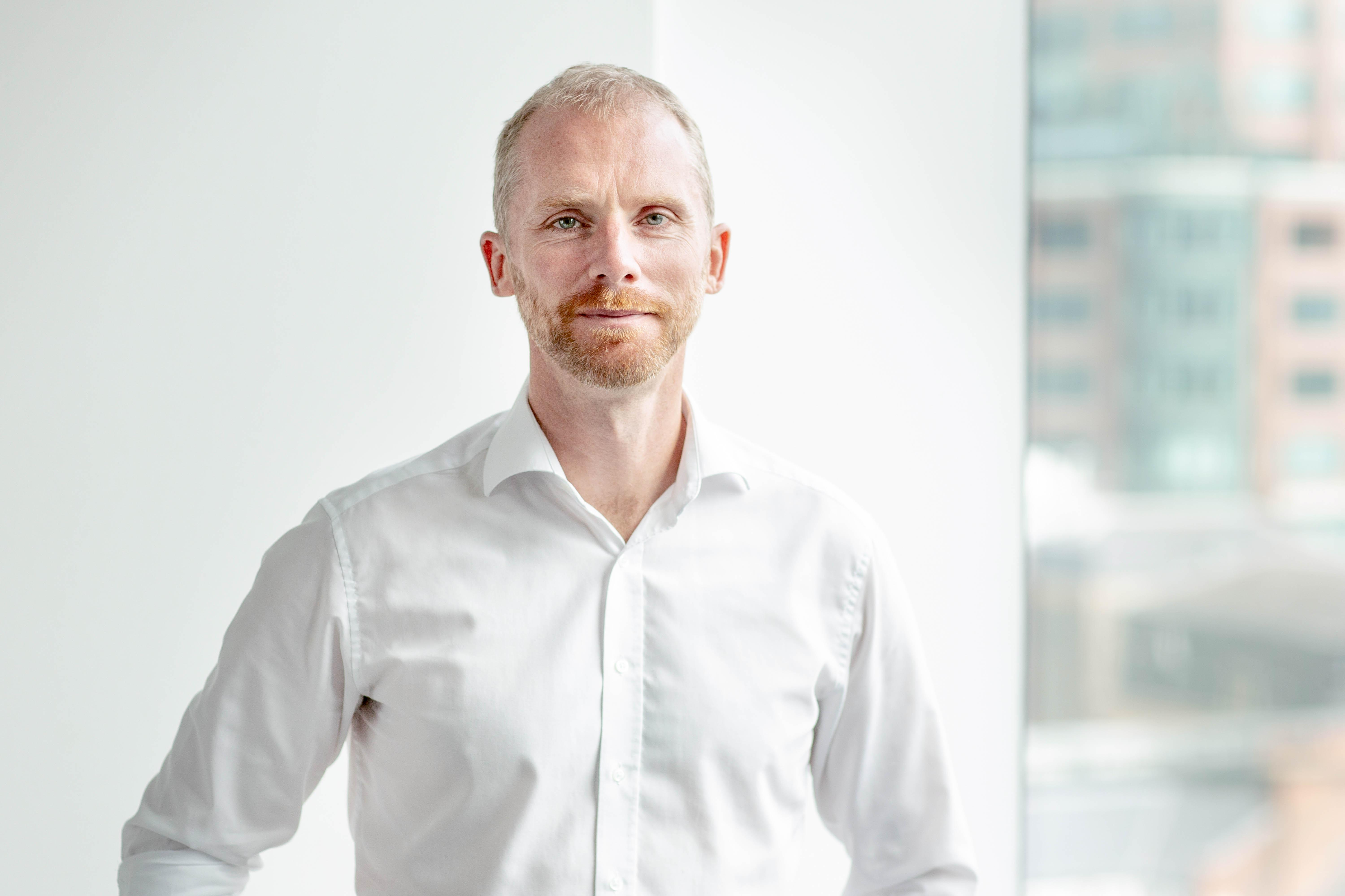 Wayne Barnes standing against white wall