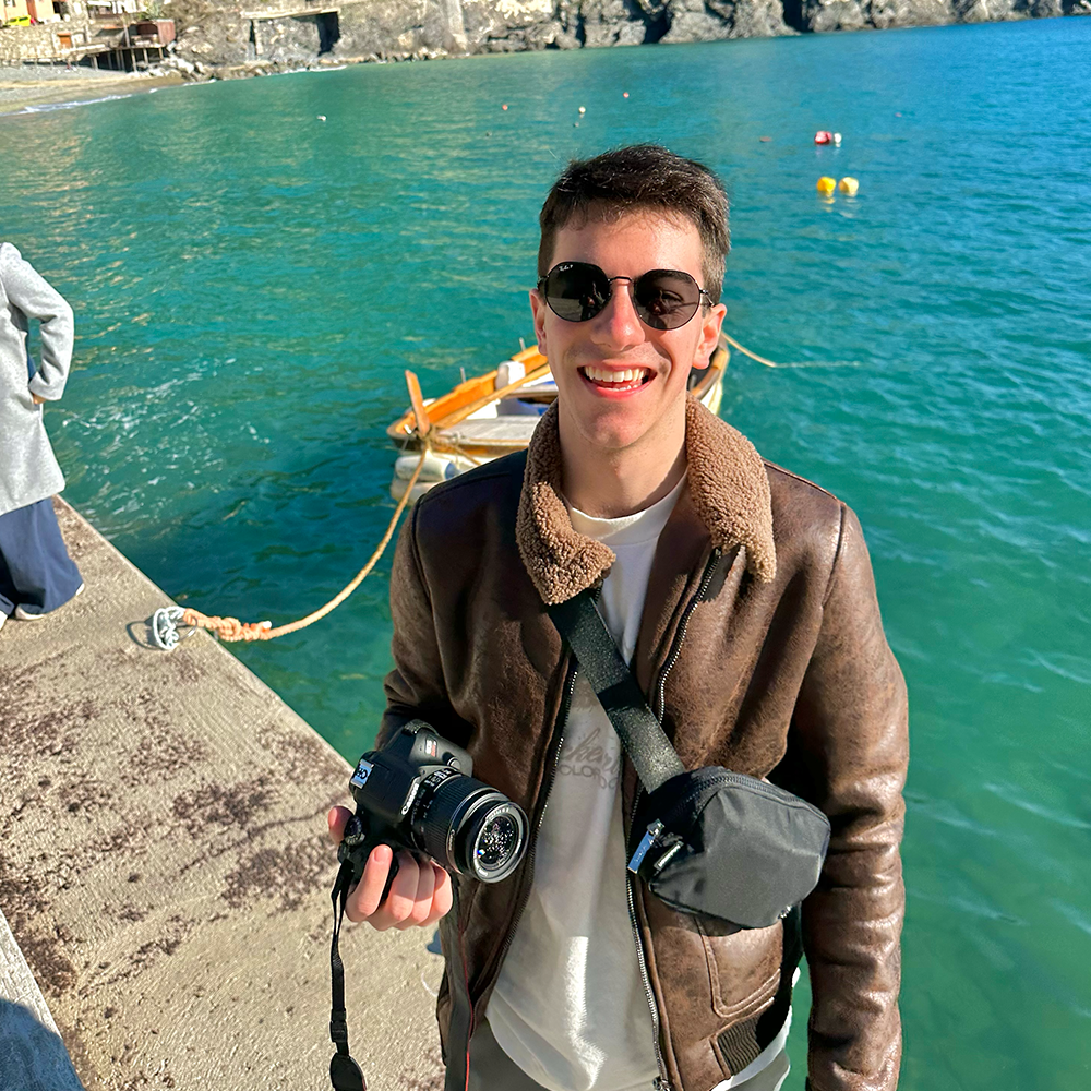 Student stands in front of water