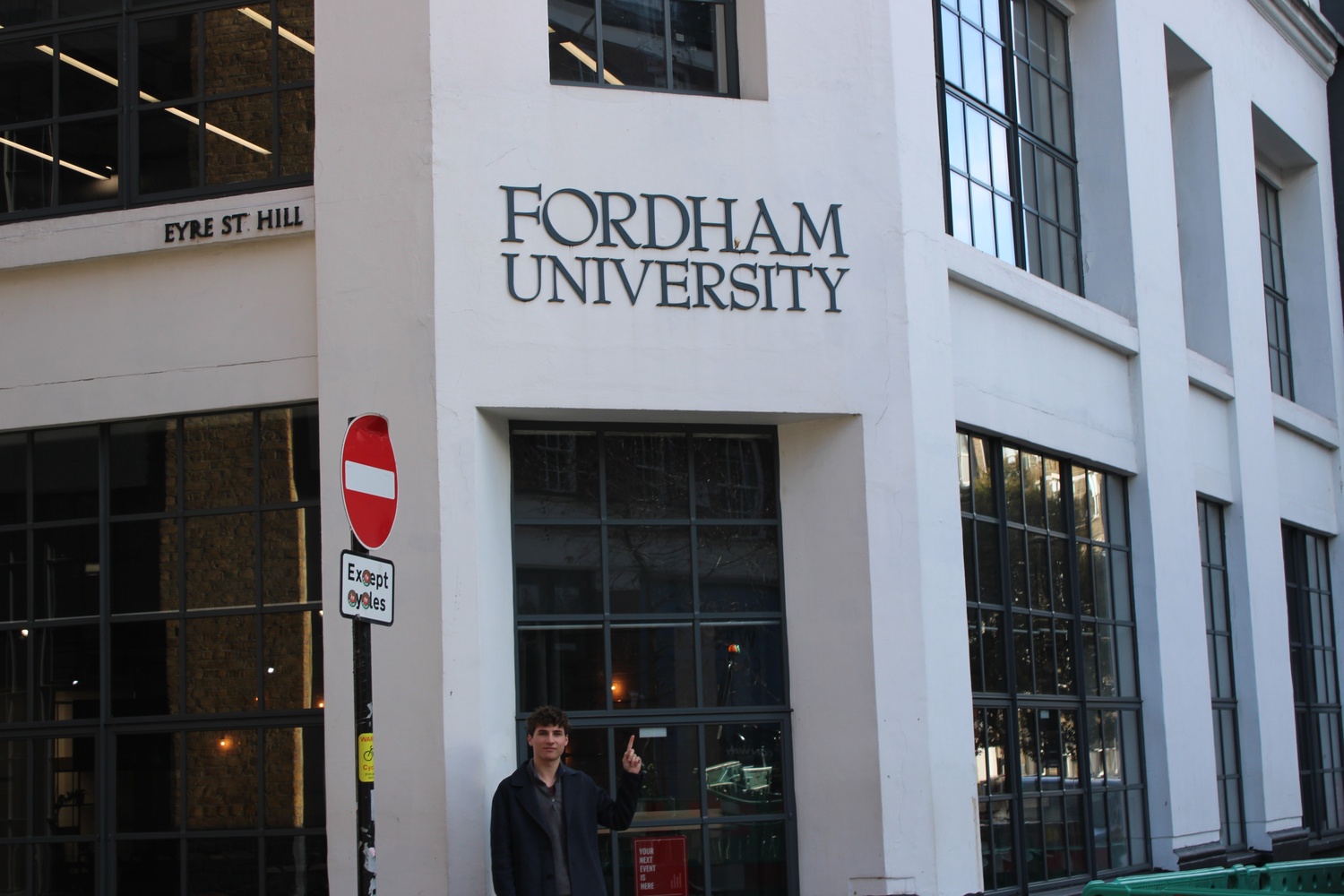 Student waving at the beach