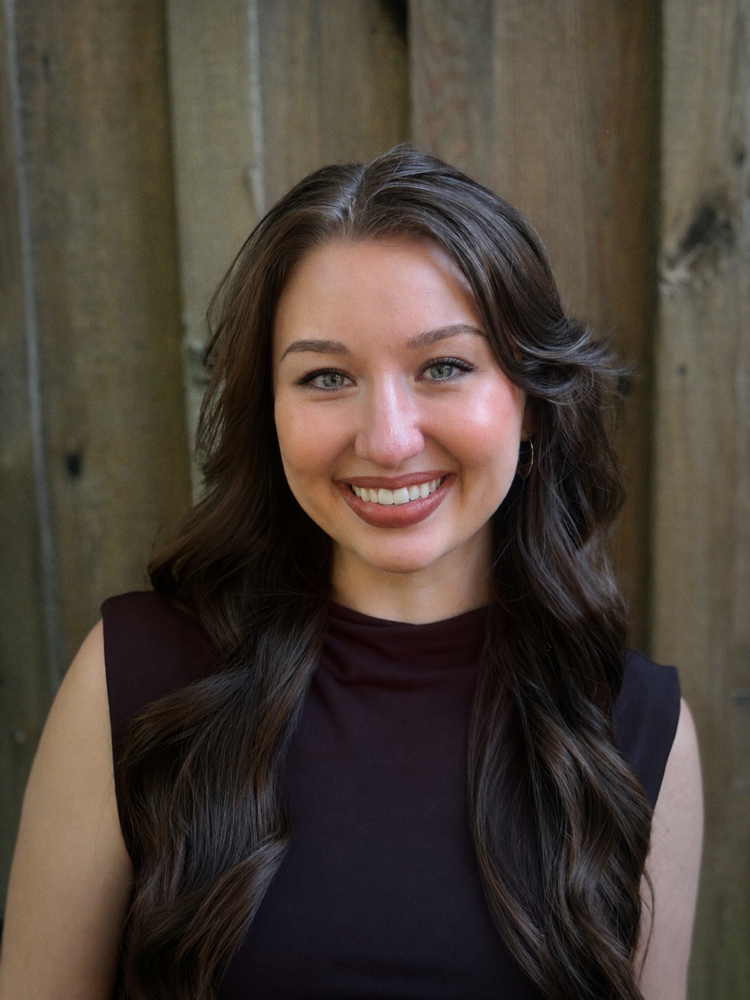 A headshot photo of Makayla Bezzant, a a doctoral student in the Judaism and Christianity in Antiquity track in the Theology Department at Fordham University. Makayla is wearing a white shirt.