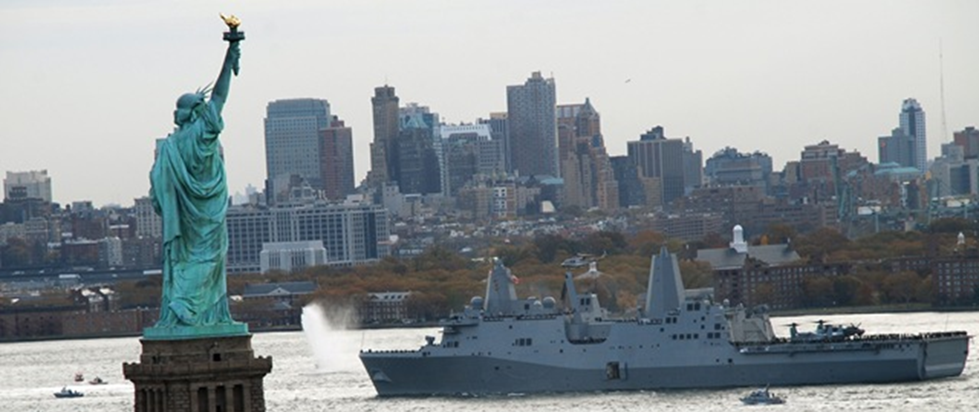 Navy ship sailing past stature of liberty