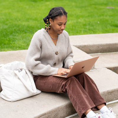 Student outside with laptop