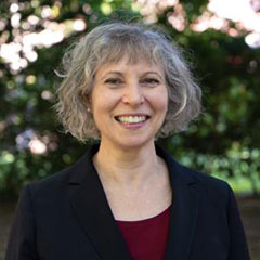 Ann Gaylin standing with trees in the background