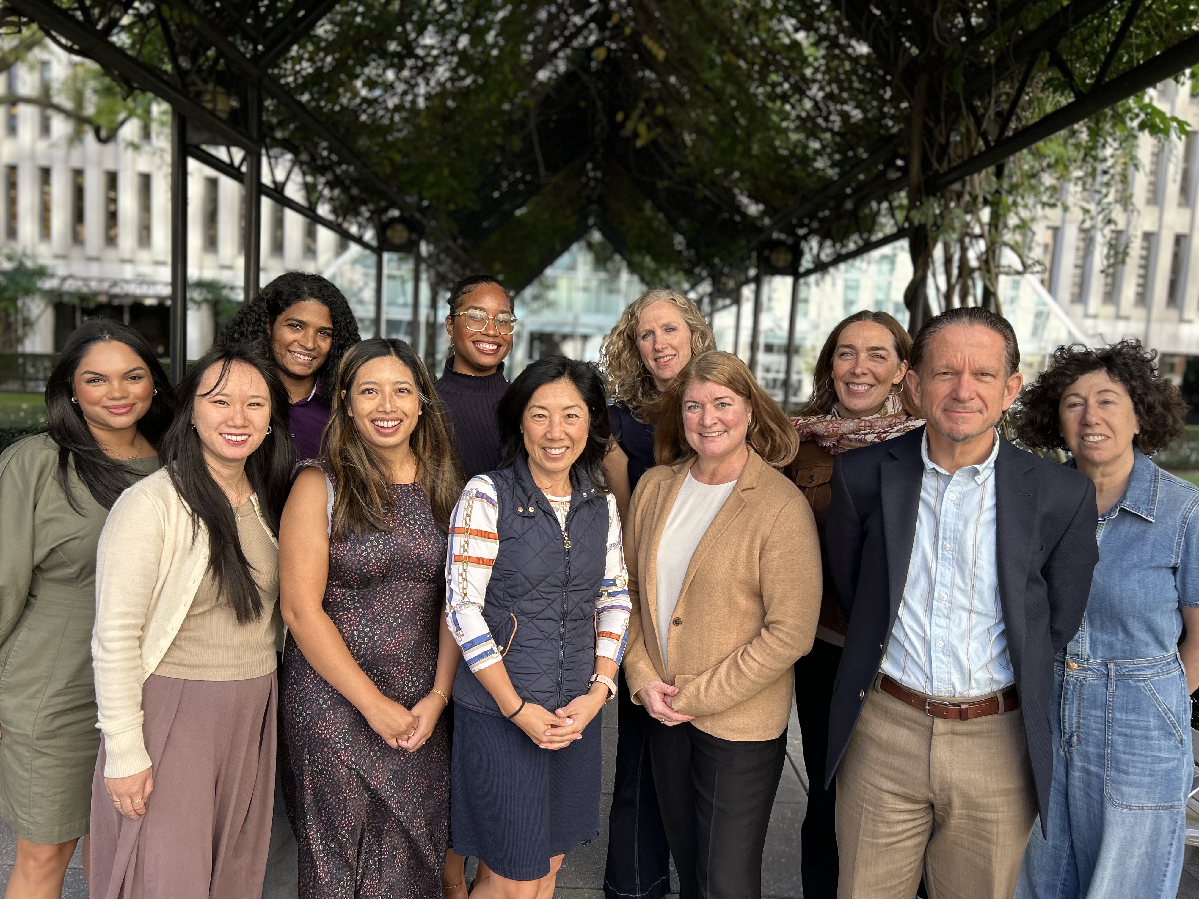A group of students and faculty from the Graduate School of Education posing for a photo on the plaza.