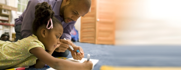 man helping young girl with her school assignment