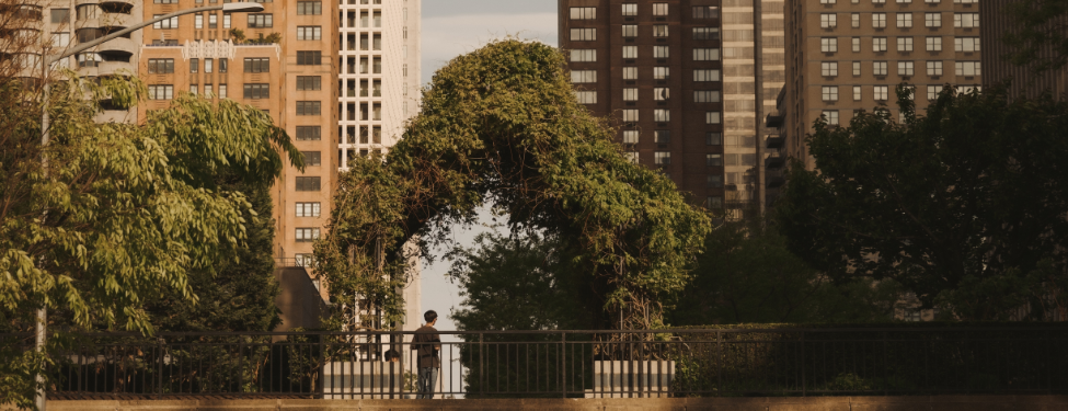 a student standing in Fordham's Lincoln Center campus courtyard.