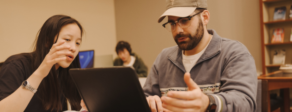 two students working at a computer.