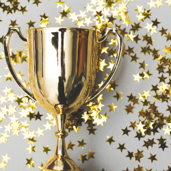 a gold trophy surrounded by gold stars