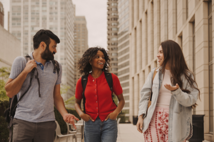 students walking and talking in the lincoln center courtyard.