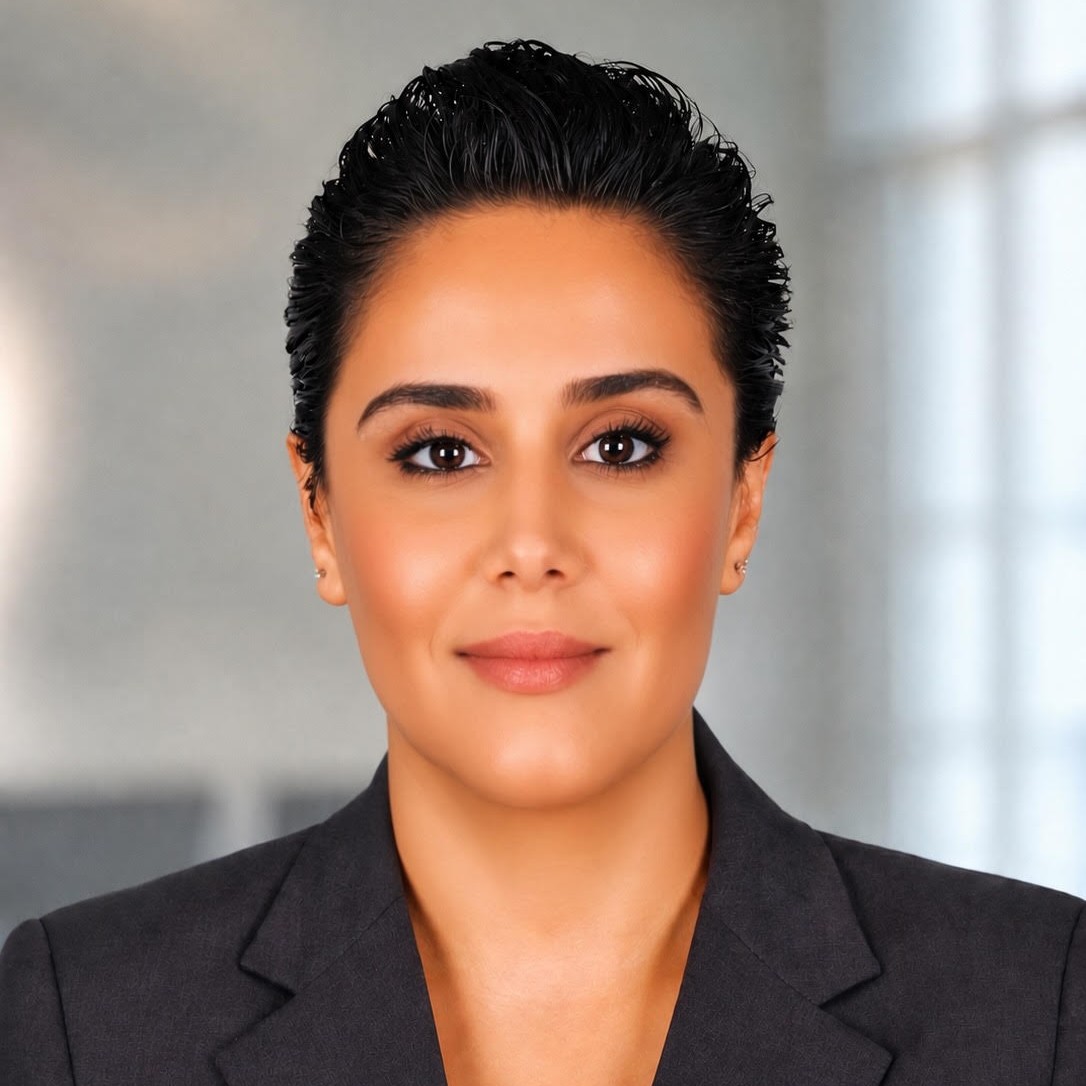 A woman with short hair wearing a black suit.