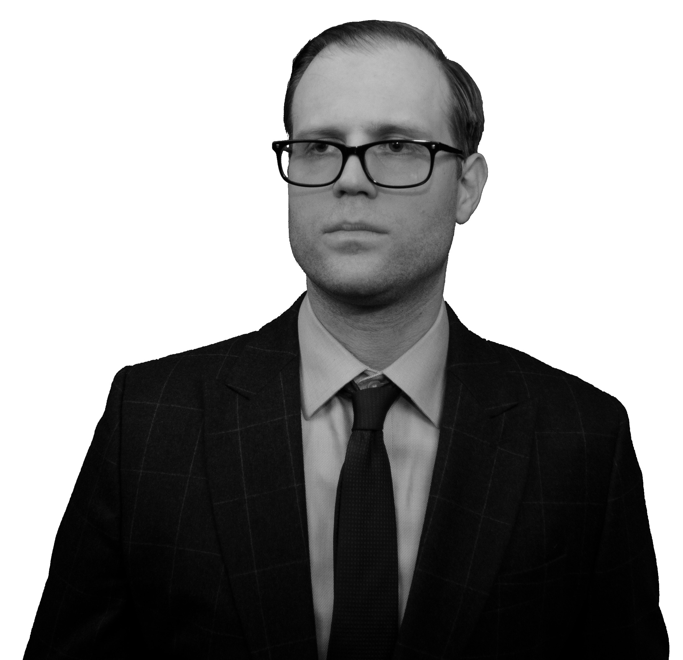A man wearing glasses and a suit with tie.