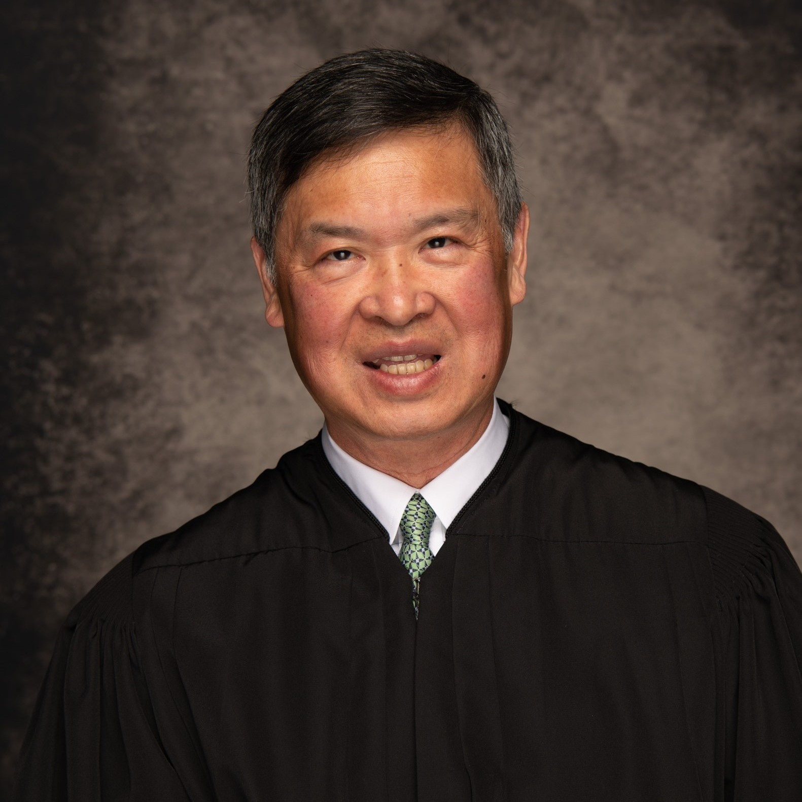 A man wearing a black robe.