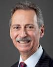 A headshot of a man with a mustache