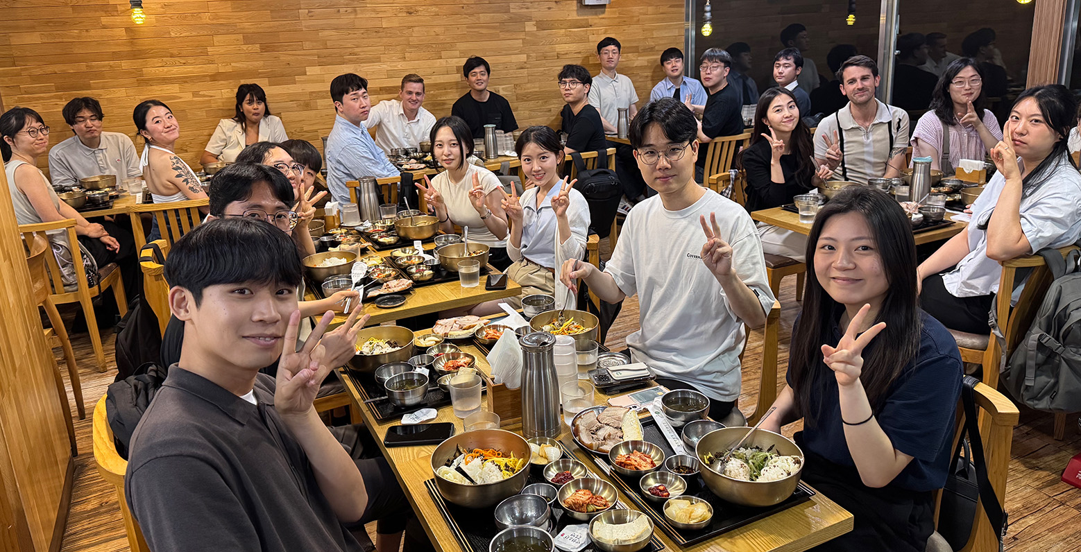 A group of students eating inside a restaurant.