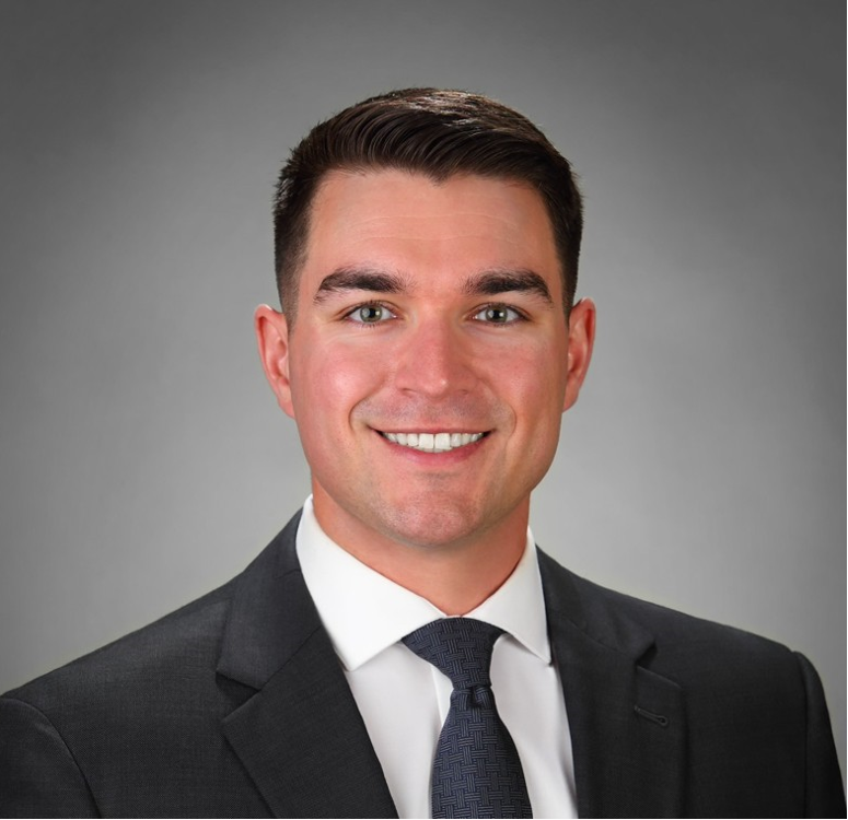 A man in a black suit and tie.