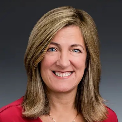 A woman wearing a red shirt.