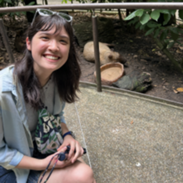 Student kneeling beside animal