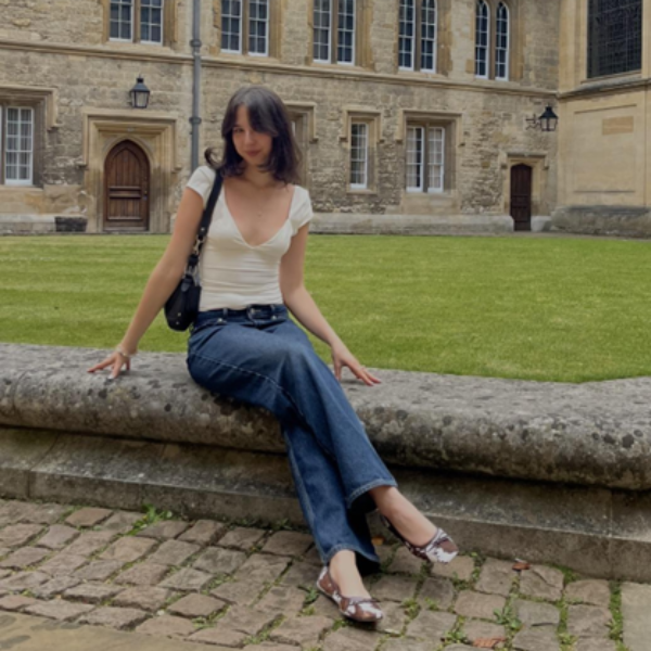 student sitting in front of a building
