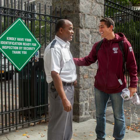 Security guard and student at entrance gate - LG